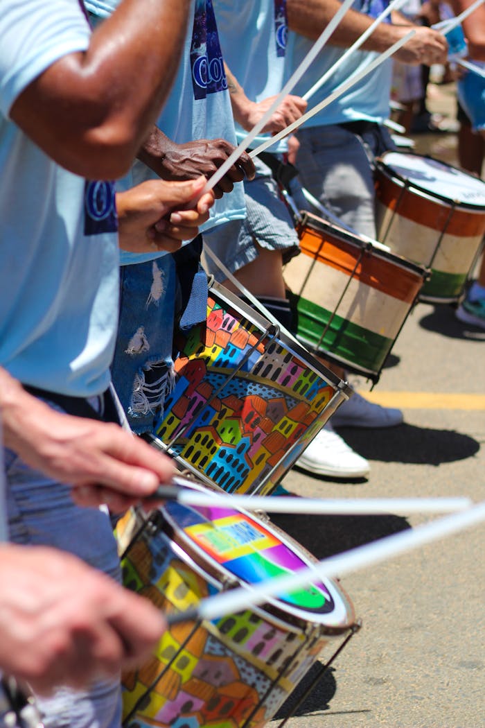 Vibrant street parade with people drumming. Ideal for festival and music themes.