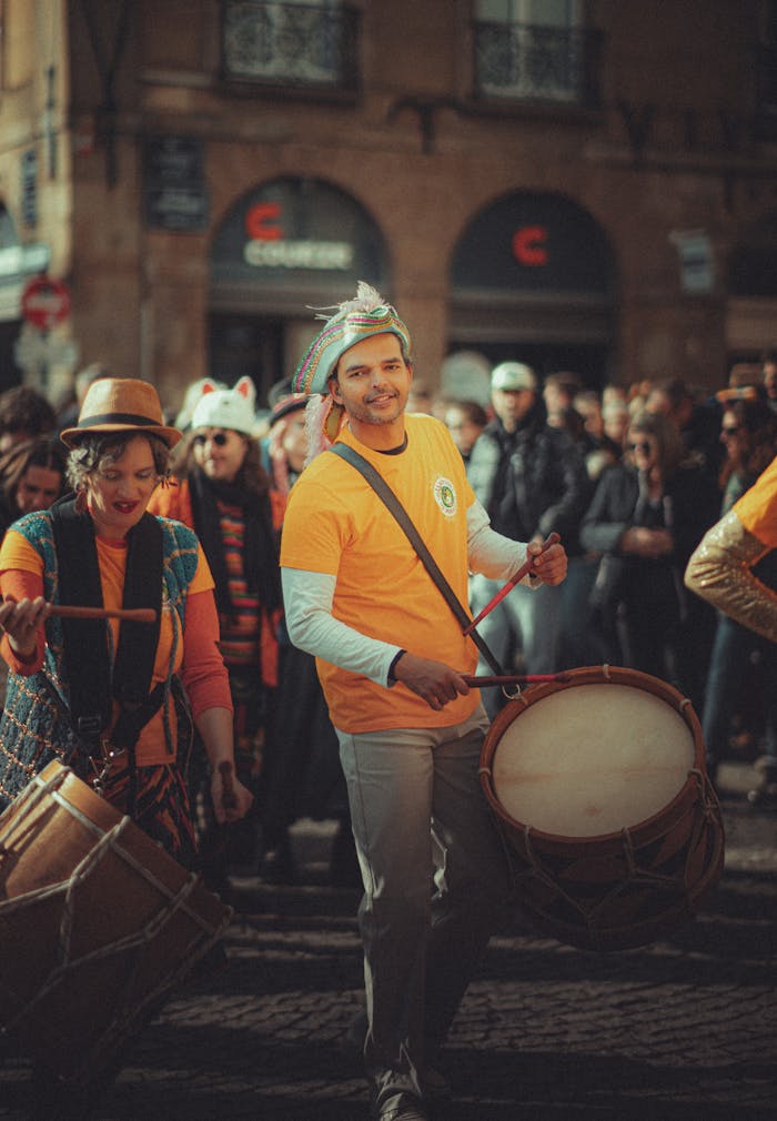 A vibrant street scene with musicians playing drums at an outdoor festival.