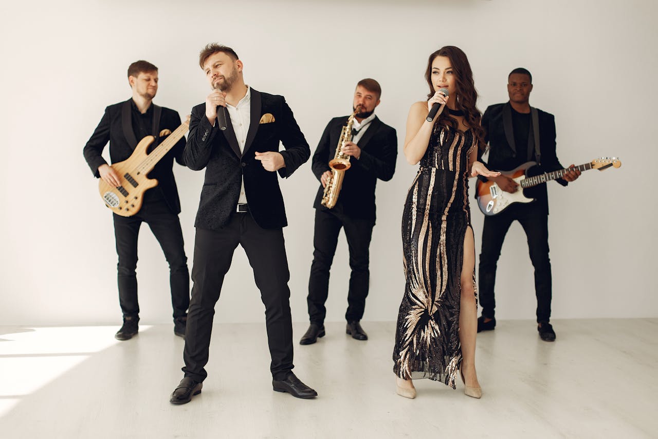 A stylish jazz band performing indoors with two vocalists and musicians in black attire.